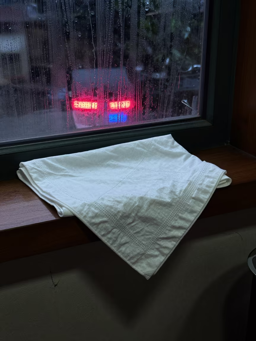 Folded Blanket and Handkerchief in Mongu Predawn in on a painted display ledge in Mongu