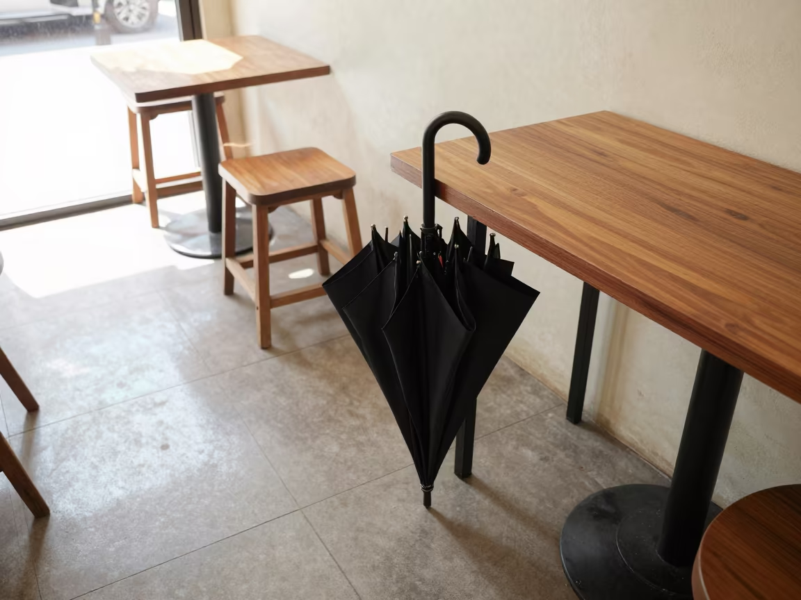 Folded Umbrella Drying on Cafe Table in on a cafe table by a window in Yangon
