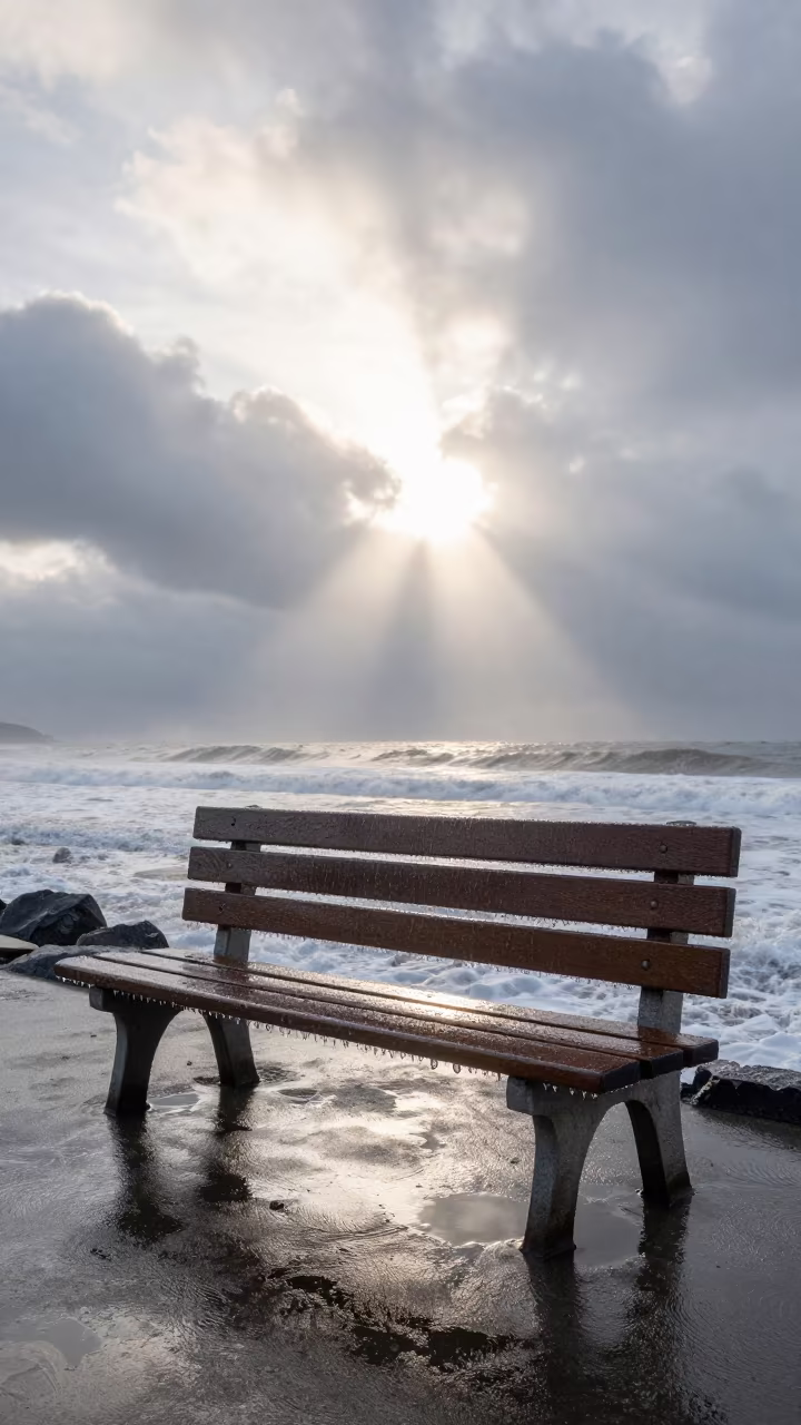 Freezing Rain Coats Park Bench at Dawn in beneath fast-moving cloud bands near Medan