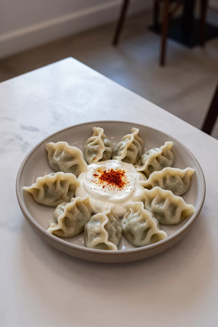 Fresh Manti Dumplings Garlic Yogurt Early Summer Light in on a marble cafe table in New York