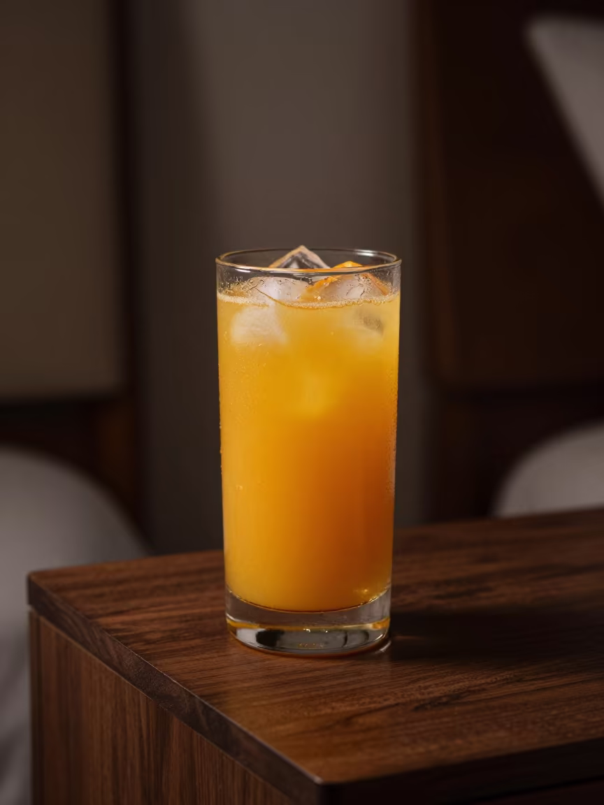 Fresh Orange Juice in Nightly Lamp Light in on a bedside table in Maracaibo