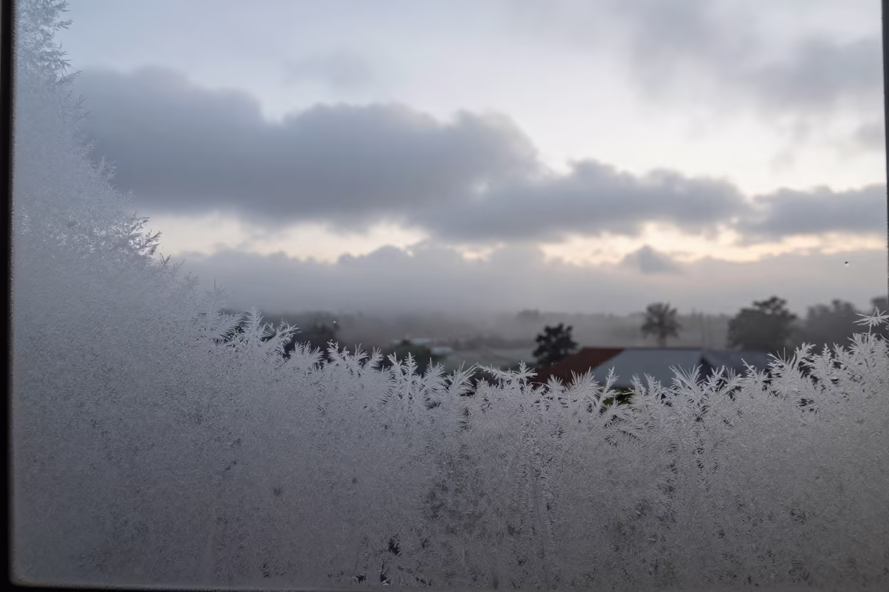 Frost Crystals on Window Over Thunderheads in over a horizon of stacked thunderheads near Jinja