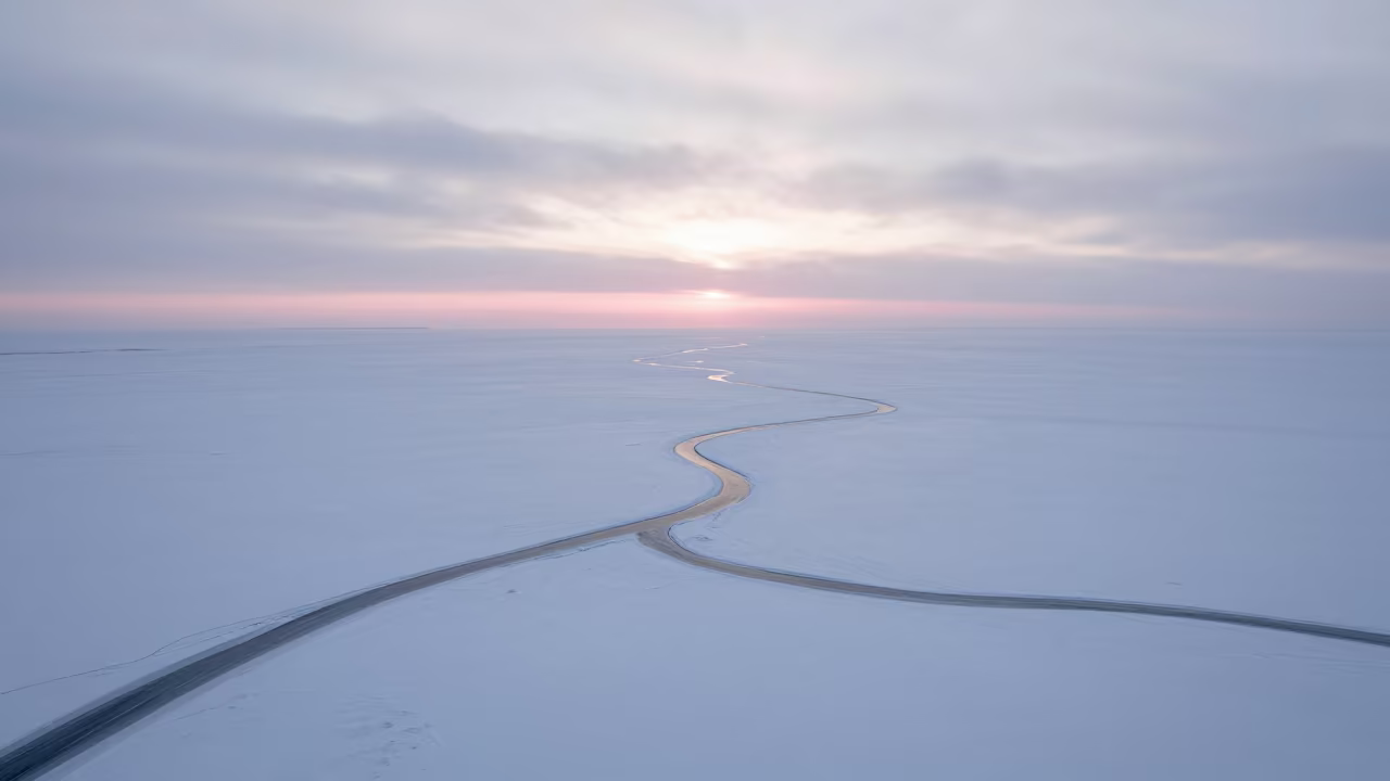 Frozen Braided River Carving White Tundra in high above braided river channels in Canada
