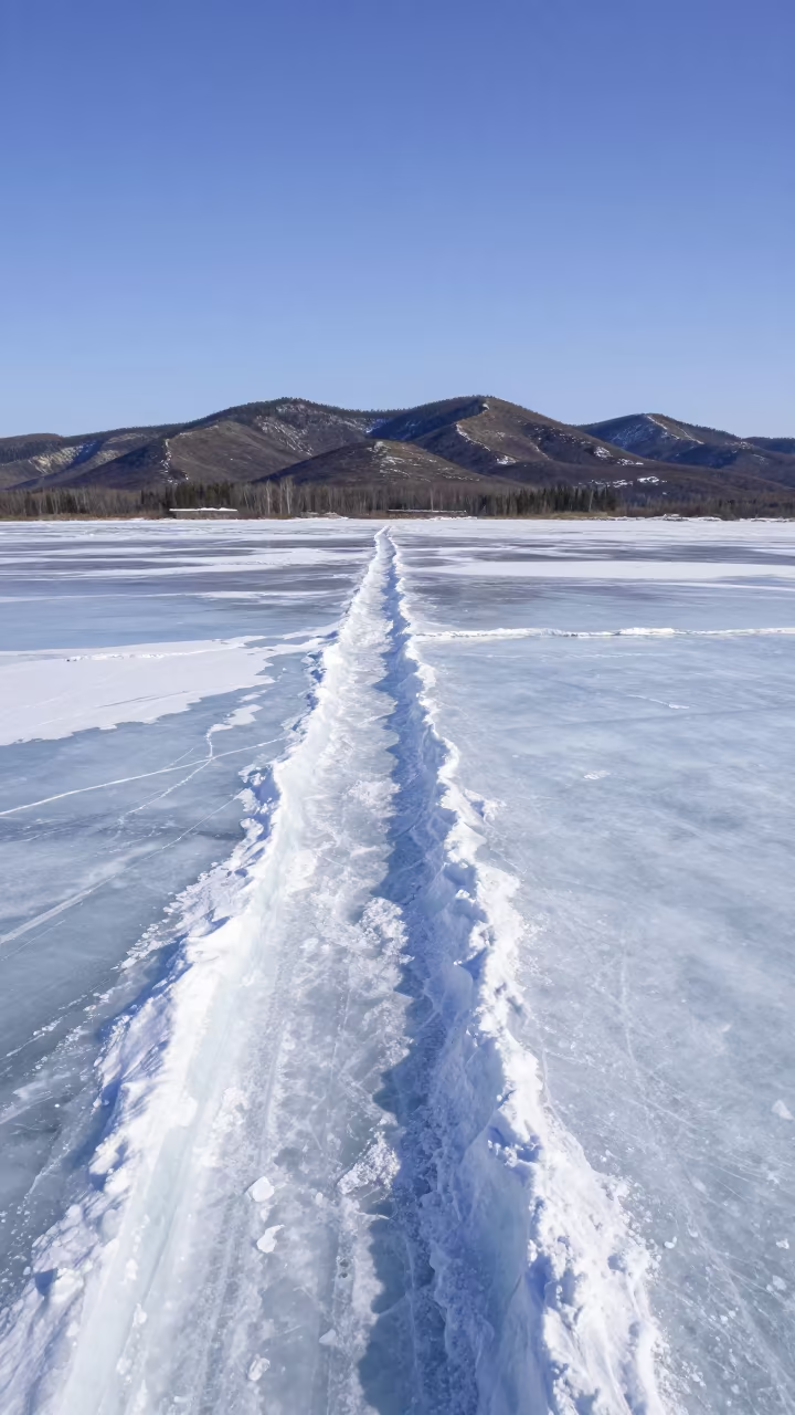 Frozen River Pressure Ridges Under Noon Light in from a ridge above layered foothills in Canada