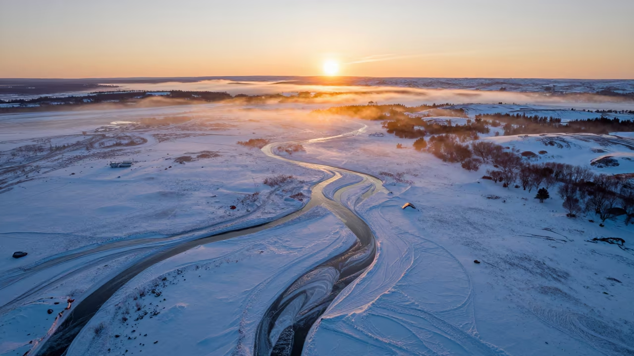 Frozen Siberian River Golden Hour Aerial in high above braided river channels in Siberia