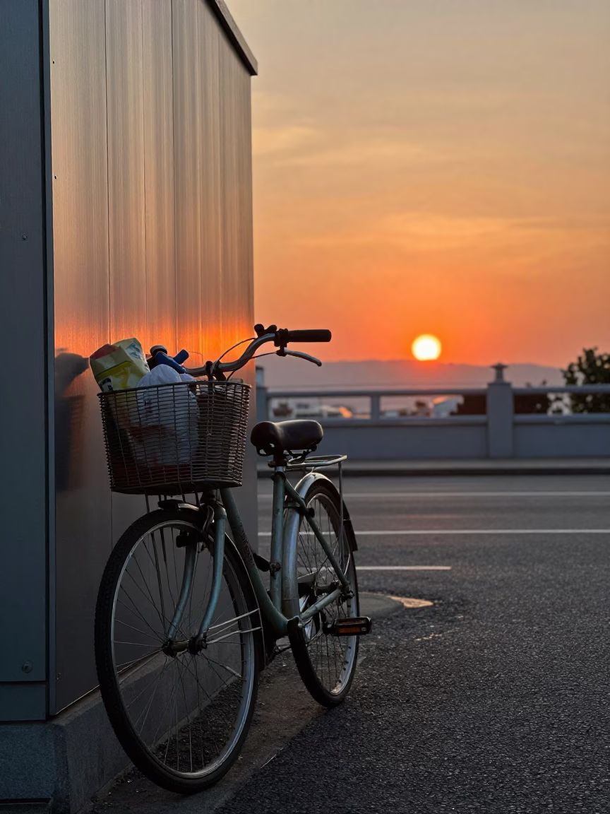 Fukuoka street scene at sunset with bicycle basket and brushed steel wall in in Fukuoka, Japan