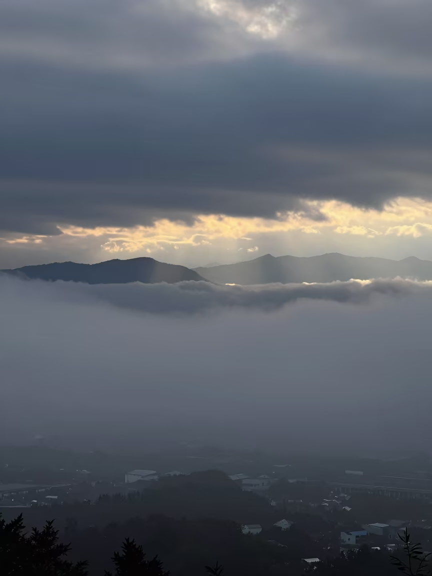 Fukuoka Valley Fog Sea at Dawn Rim Light in over a horizon of stacked thunderheads near Fukuoka