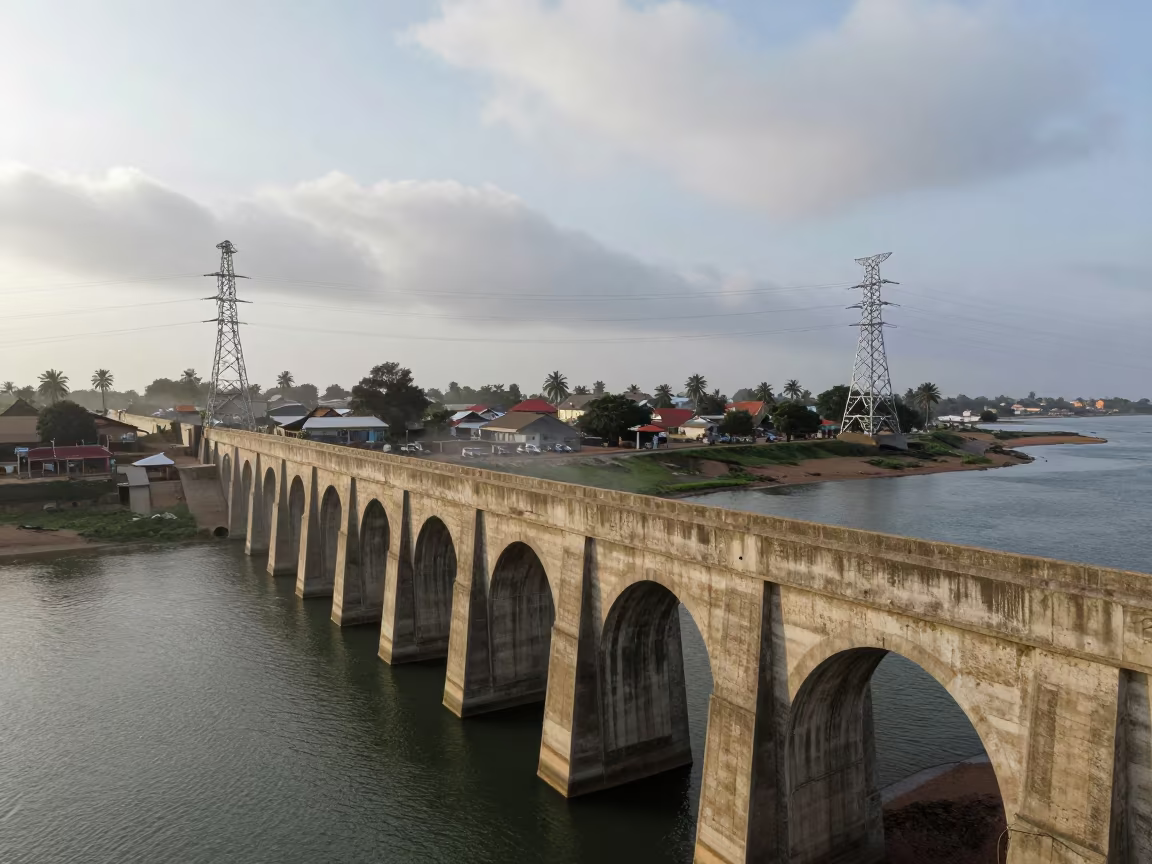 Gambia Aqueduct Under Monsoon Heat in beneath transmission towers in Gambia