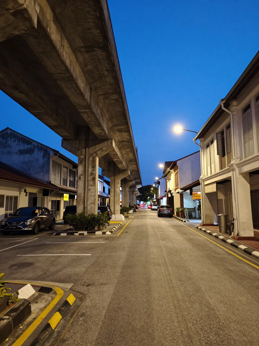 George Town Malaysia indigo twilight street scene with vintage 1980s aesthetics and local life in in George Town, Malaysia