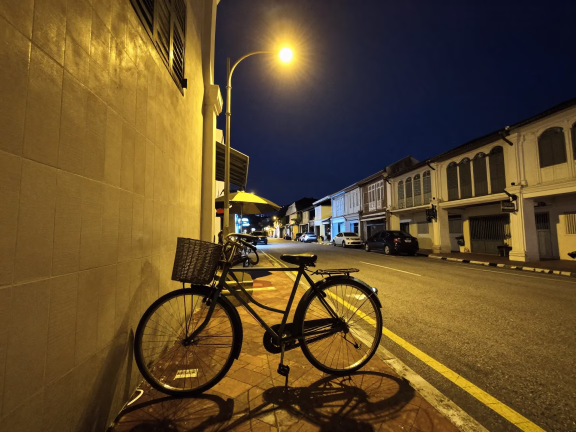 George Town Malaysia Night Street Scene with Bicycle Basket and Umbrella Stand in in George Town, Malaysia