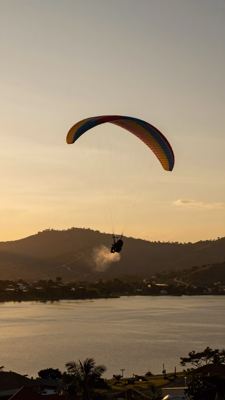 Giant Paraglider Stalled Over Calm Lake at Sunset in on a mountain path near Barranquilla