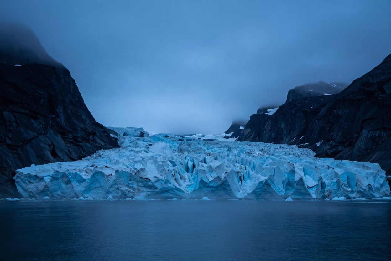 Glacier Calving Into Fjord During Polar Night in across a wide valley floor near Kiruna