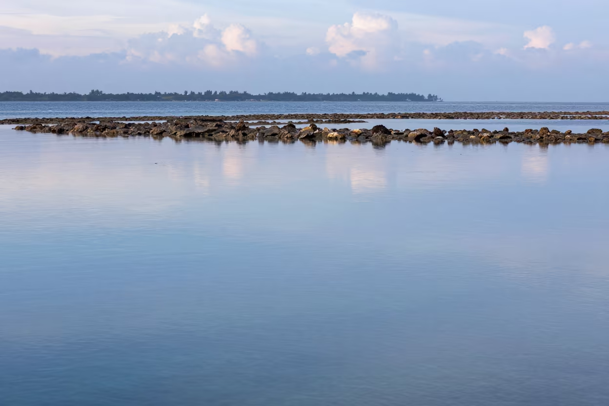 Glass Calm Lagoon Behind Reef Near Stone Town in along a coral wall with blue water beyond near Stone Town