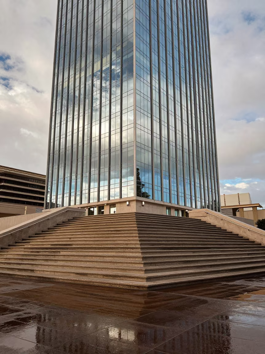 Glass Curtain Wall Reflections on Wet Paving in at the base of a monumental staircase in Las Vegas