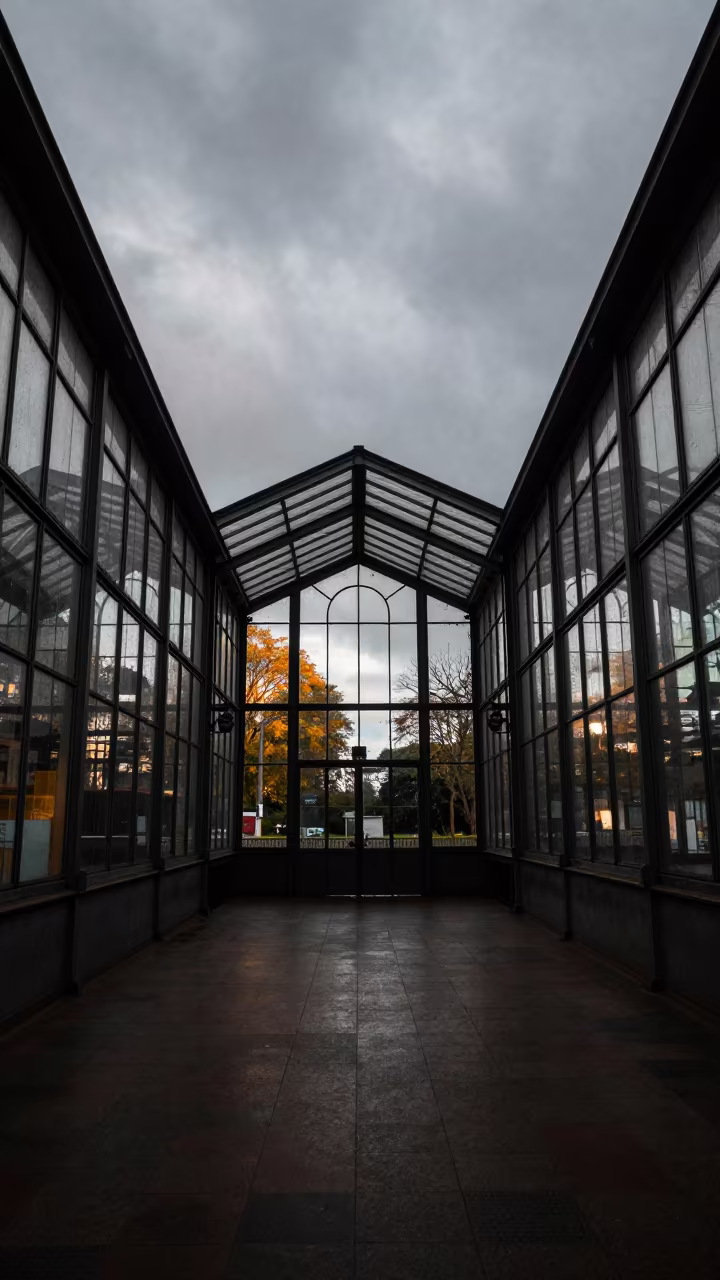 Glass Pavilion Reflects Autumn Trees in inside a restored train terminal in Cayenne