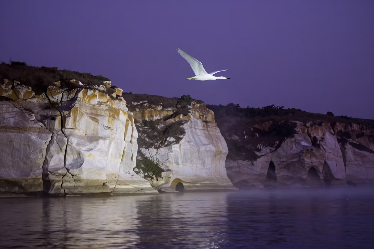 Glider Circling Chalk Cliffs at Twilight in in Gabon