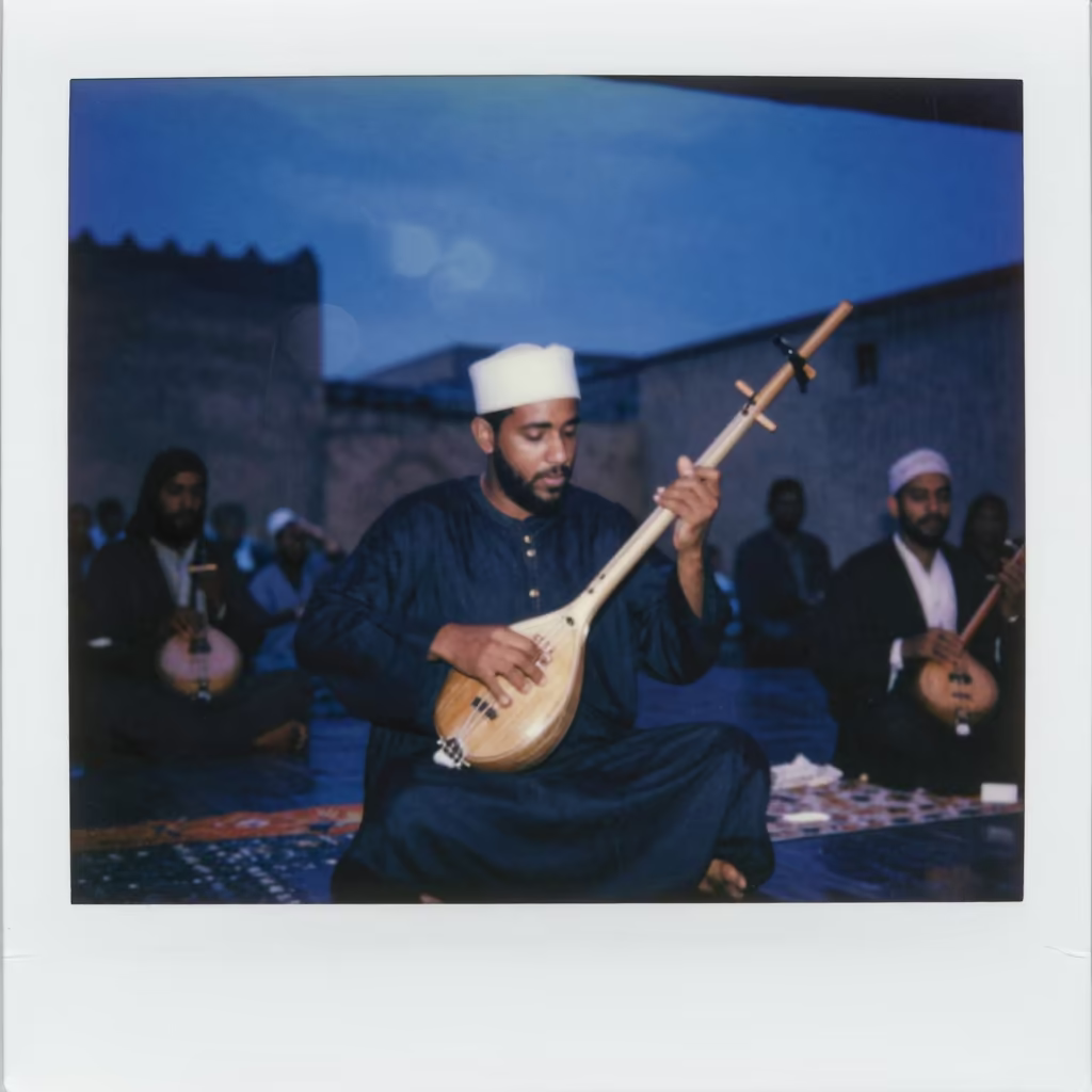 Gnawa Musician Plays Guembri on Fez Stage in on a dimly lit stage in Fez
