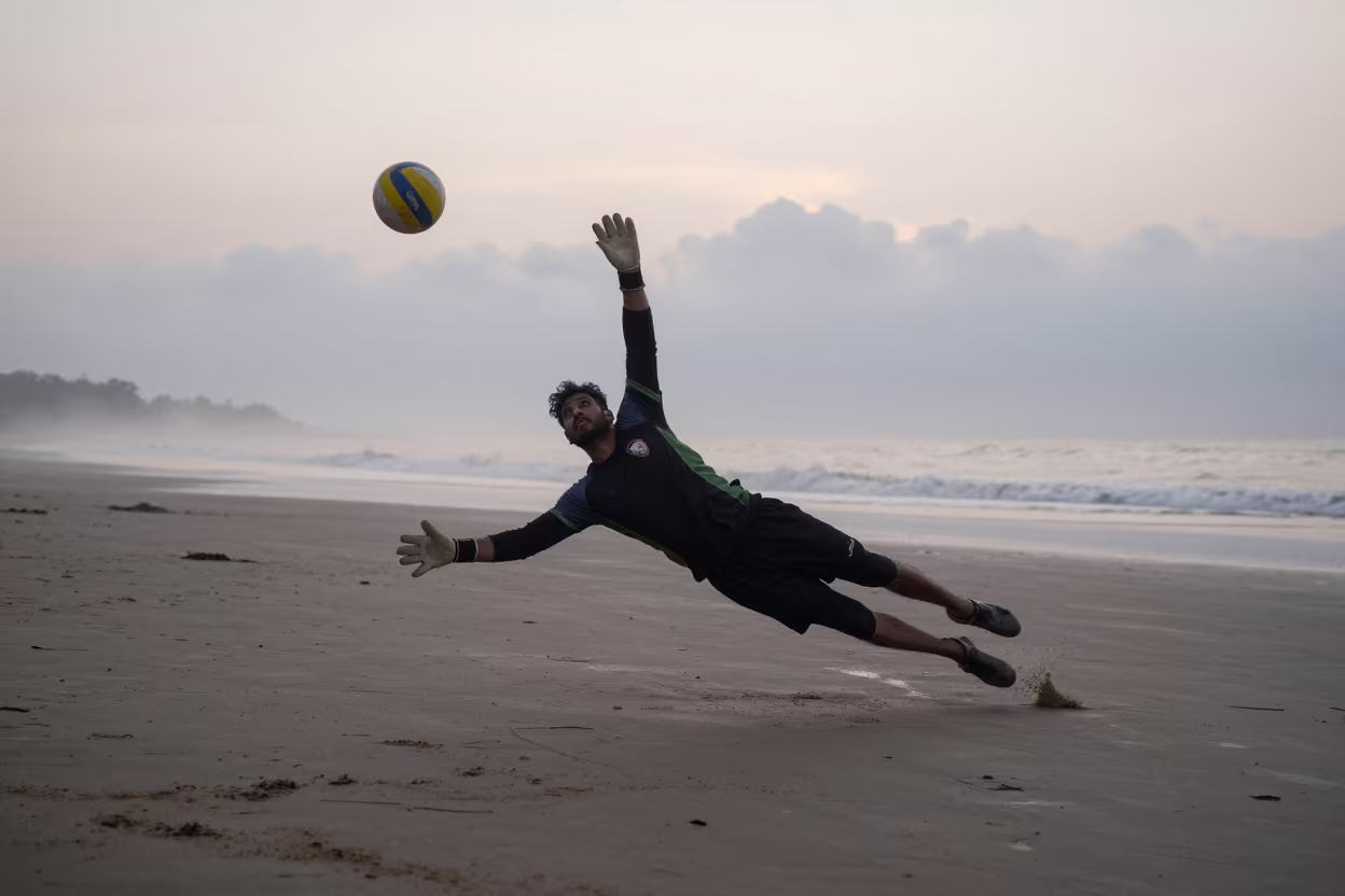 Goalkeeper Dives in Mist Before Sunrise in along a beach near Khulna