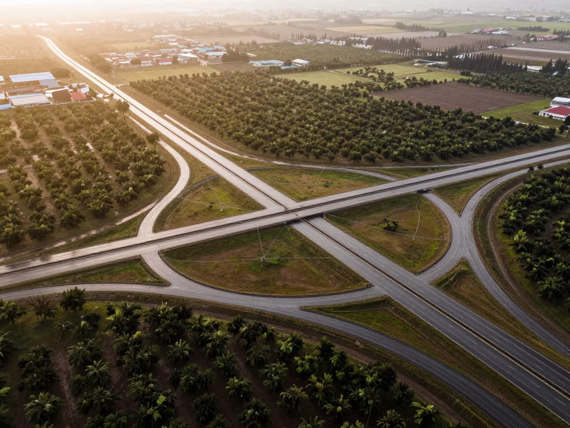 Golden Hour Aerial View of Peruvian Highway Cloverleaf in far above orchard blocks and irrigation lines in Peru