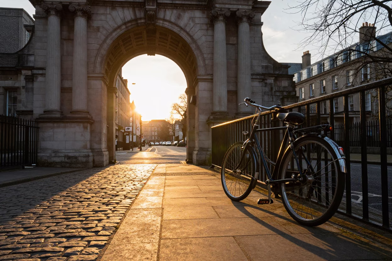 Golden Hour Dublin Street Scene with Vintage Bicycle and University Archway Framing the Cityscape in in Dublin, Ireland