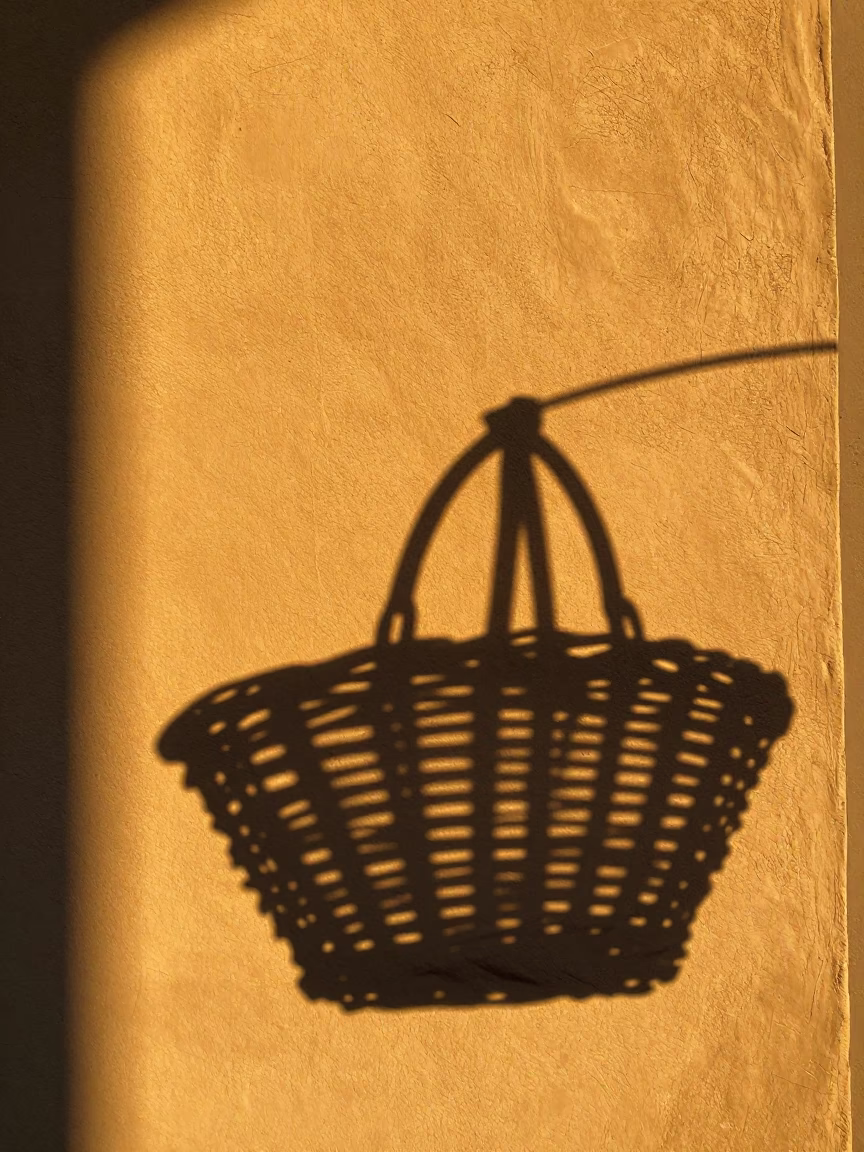 Golden Hour Light Casts Wicker Shadow On Plaster Wall In Florence Italy in in Florence, Italy