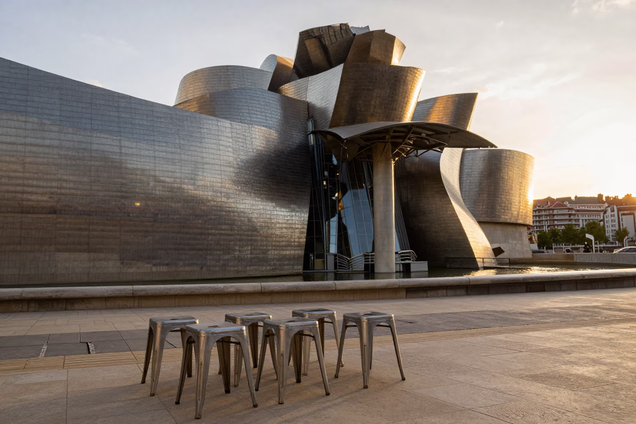 Golden Hour Light on Guggenheim Bilbao Metal Stools and Street Life in in Bilbao, Spain