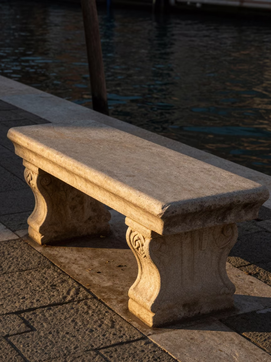 Golden Hour Light on Venetian Stone Bench Near Grand Canal Water in in Venice, Italy