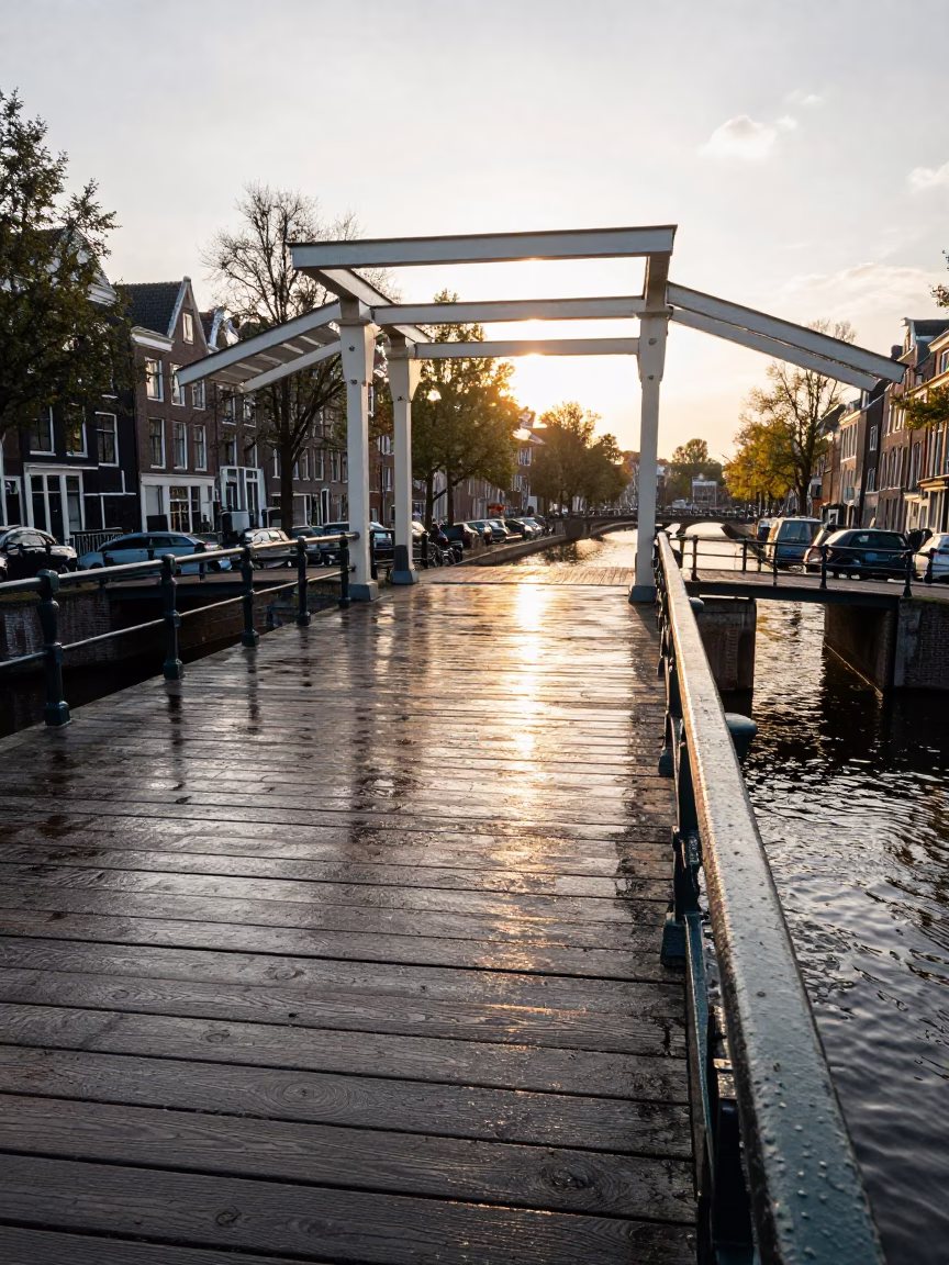 Golden Hour Light Reflecting on Amsterdam Canal Bridge Deck and River Water in in Amsterdam, Netherlands