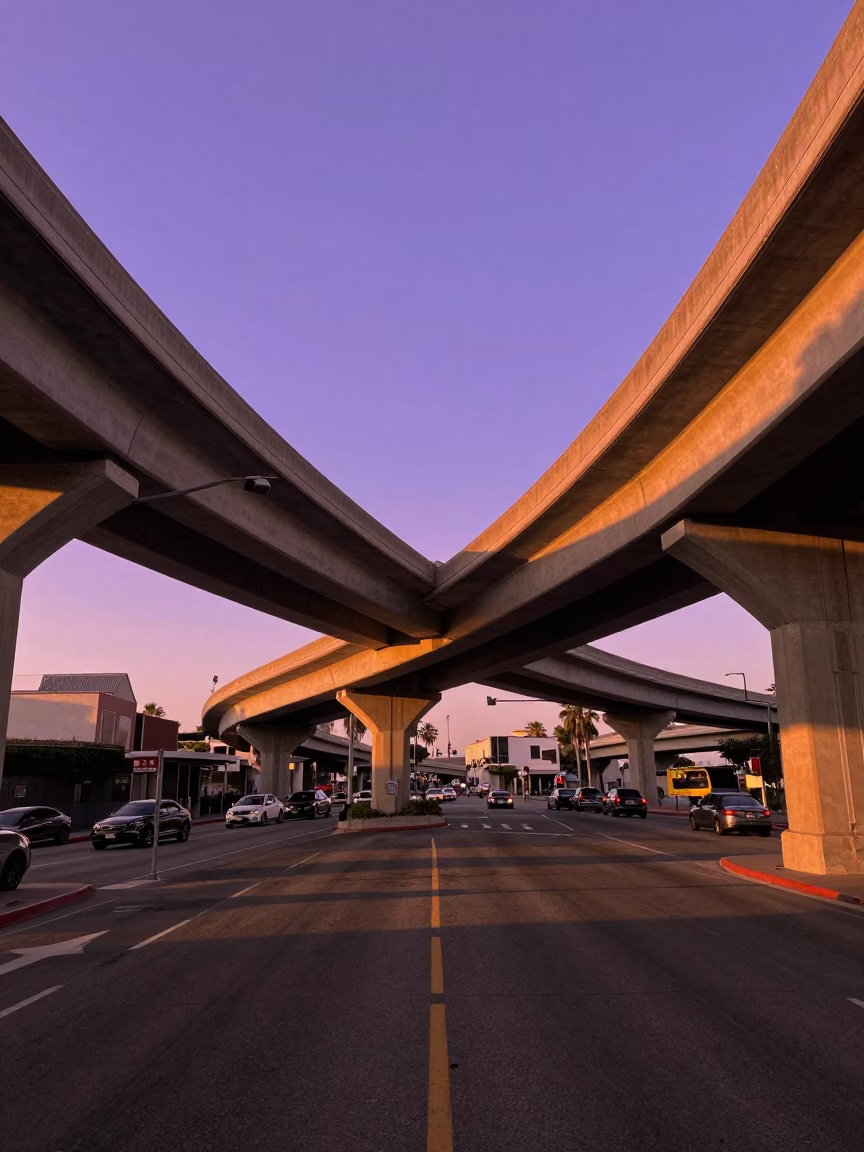 Golden Hour Los Angeles Overpass Ramp Slicing Across Violet Evening Sky with Cityscape in in Los Angeles, California, United States