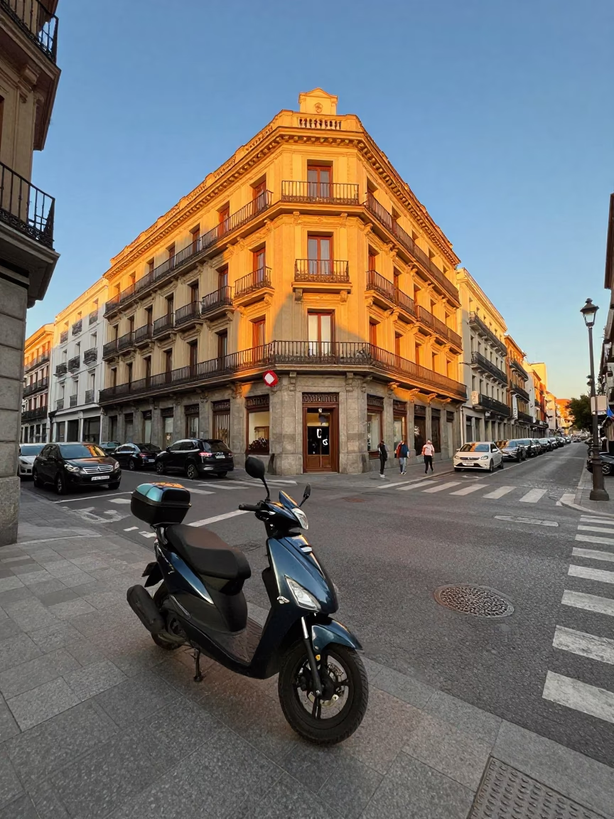Golden Hour Madrid Street Scene with Parked Scooter and Urban Architecture in in Madrid, Spain