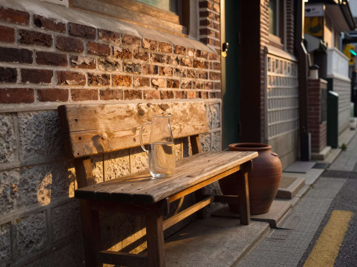 Golden Hour Seoul Street Scene with Glass Pitcher and Clay Pot on Wooden Bench in in Seoul, South Korea