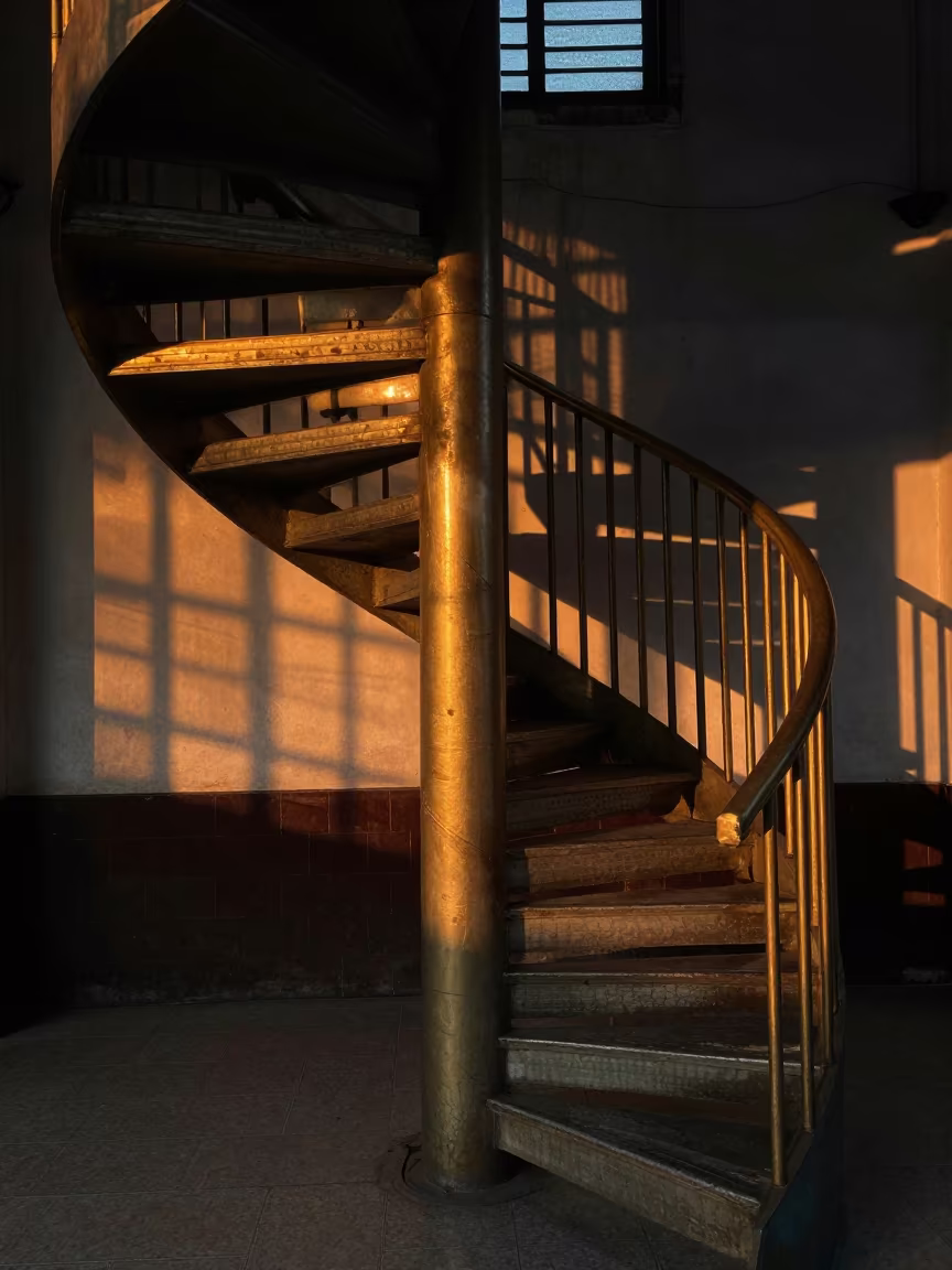 Golden Hour Shadows on Curved Staircase Wall in inside a restored train terminal in Owo
