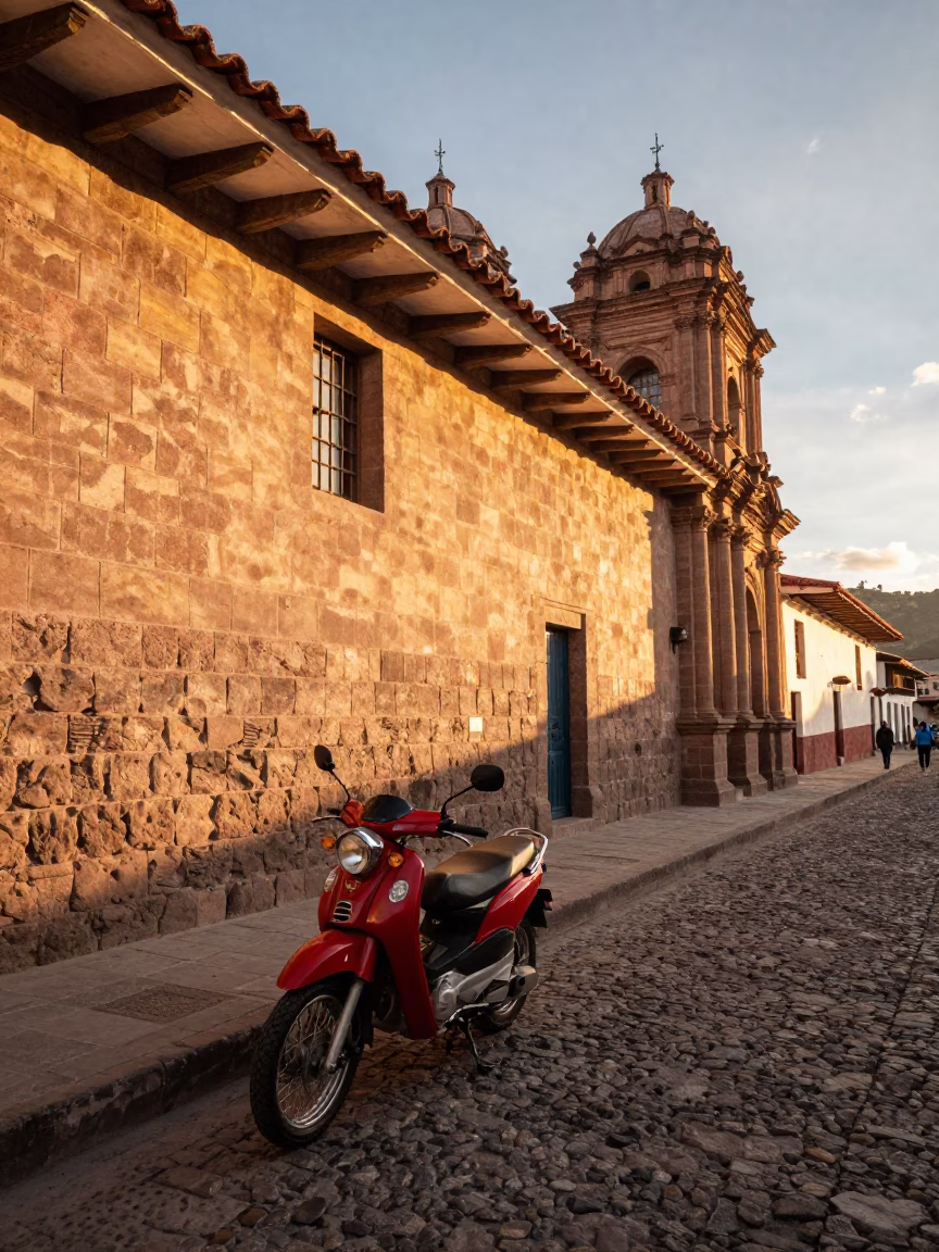 Golden Hour Street Scene in Cusco Peru with Red Motorcycle and Colonial Architecture in in Cusco, Peru