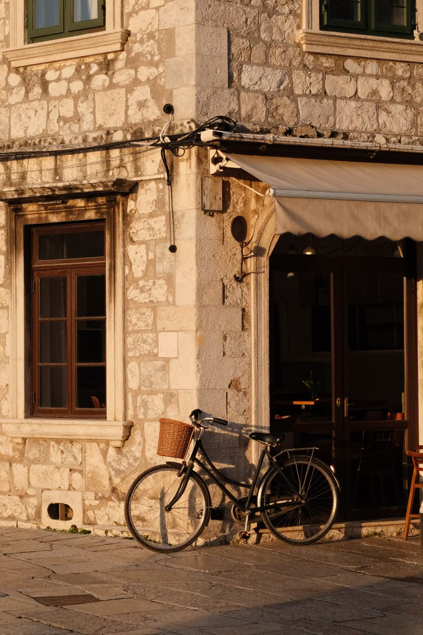 Golden Hour Street Scene in Dubrovnik Croatia with Bicycle and Cafe Exterior in in Dubrovnik, Croatia