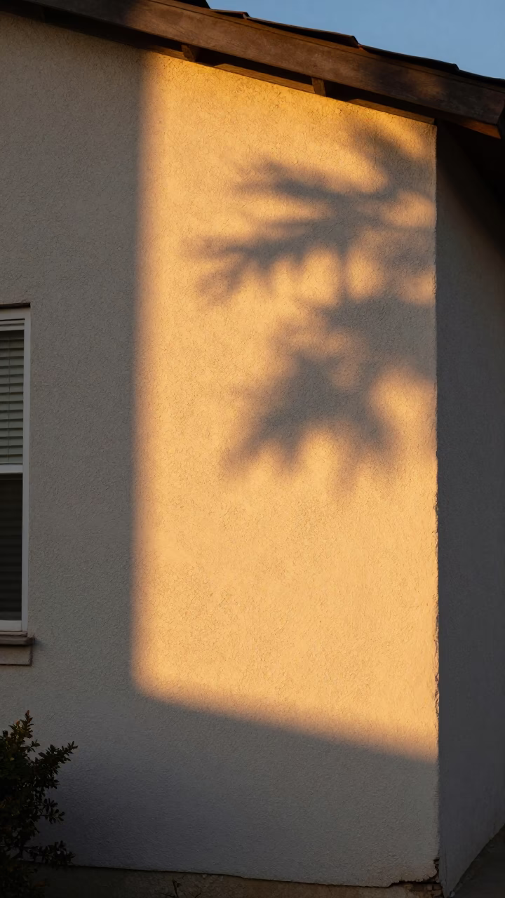 Golden Hour Sun Stripe Across Plaster Wall in Austin Texas Neighborhood in in Austin, Texas, United States