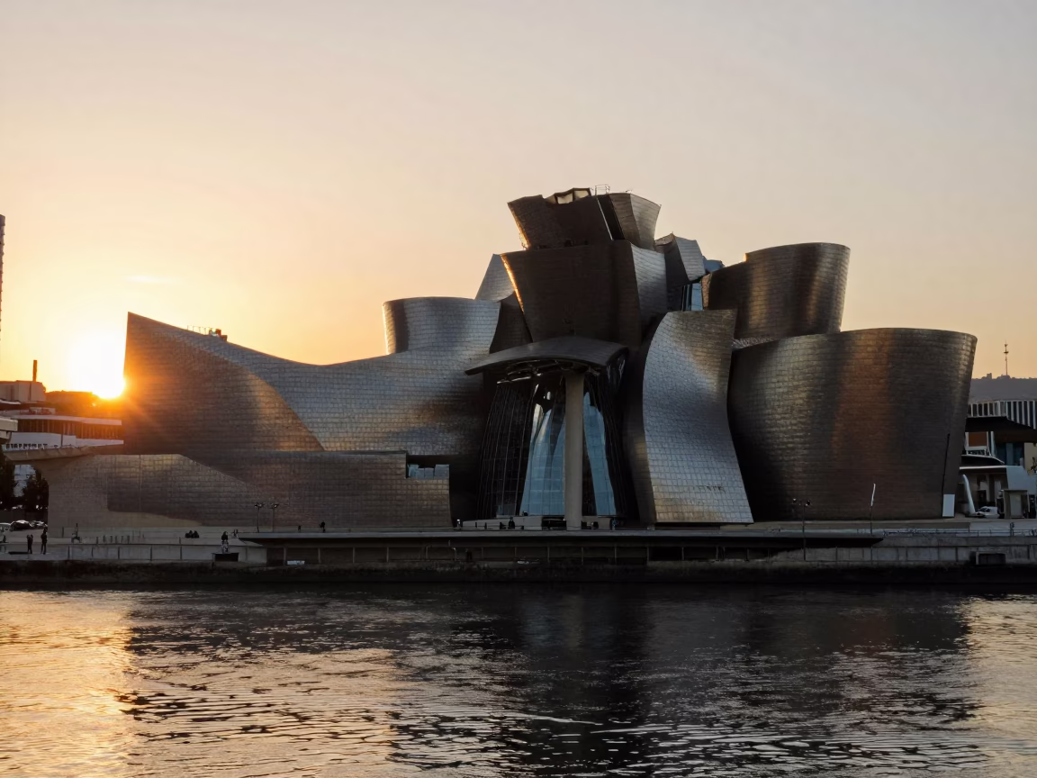 Golden Hour Sunset Illuminating Guggenheim Bilbao Architecture and Nervion River Reflections in in Bilbao, Spain