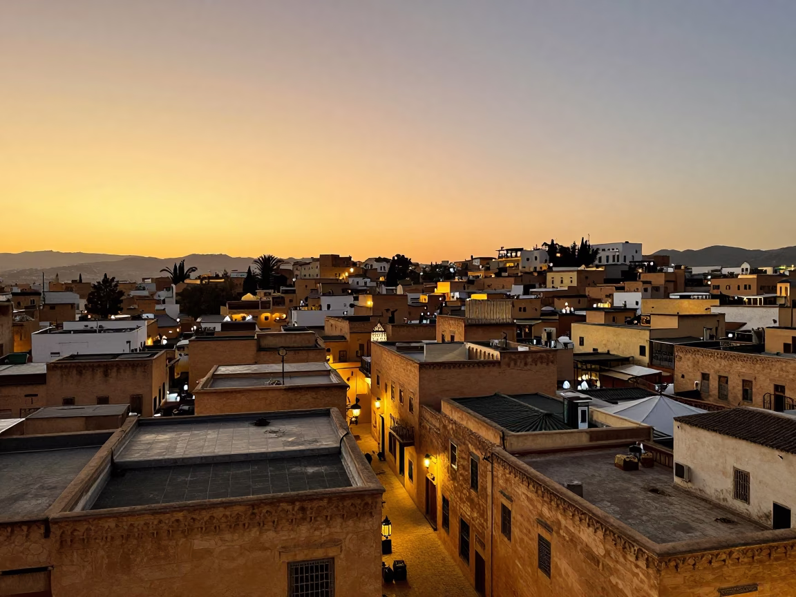 Golden Hour Sunset Over Fez Medina Rooftops and Lantern-Lit Alleyway in in Fez, Morocco