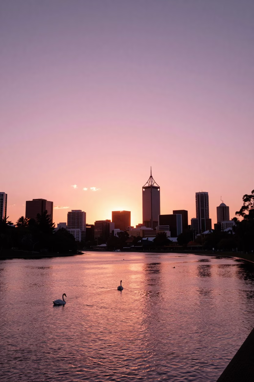 Golden Hour Sunset Over Swan River with Perth Skyline and Foreground Greenery in in Perth, Western Australia, Australia