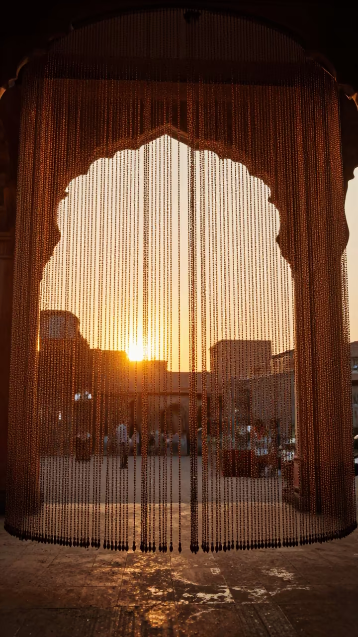 Golden Light Through Bead Curtain in Prayagraj Atrium in inside a vaulted atrium in Prayagraj