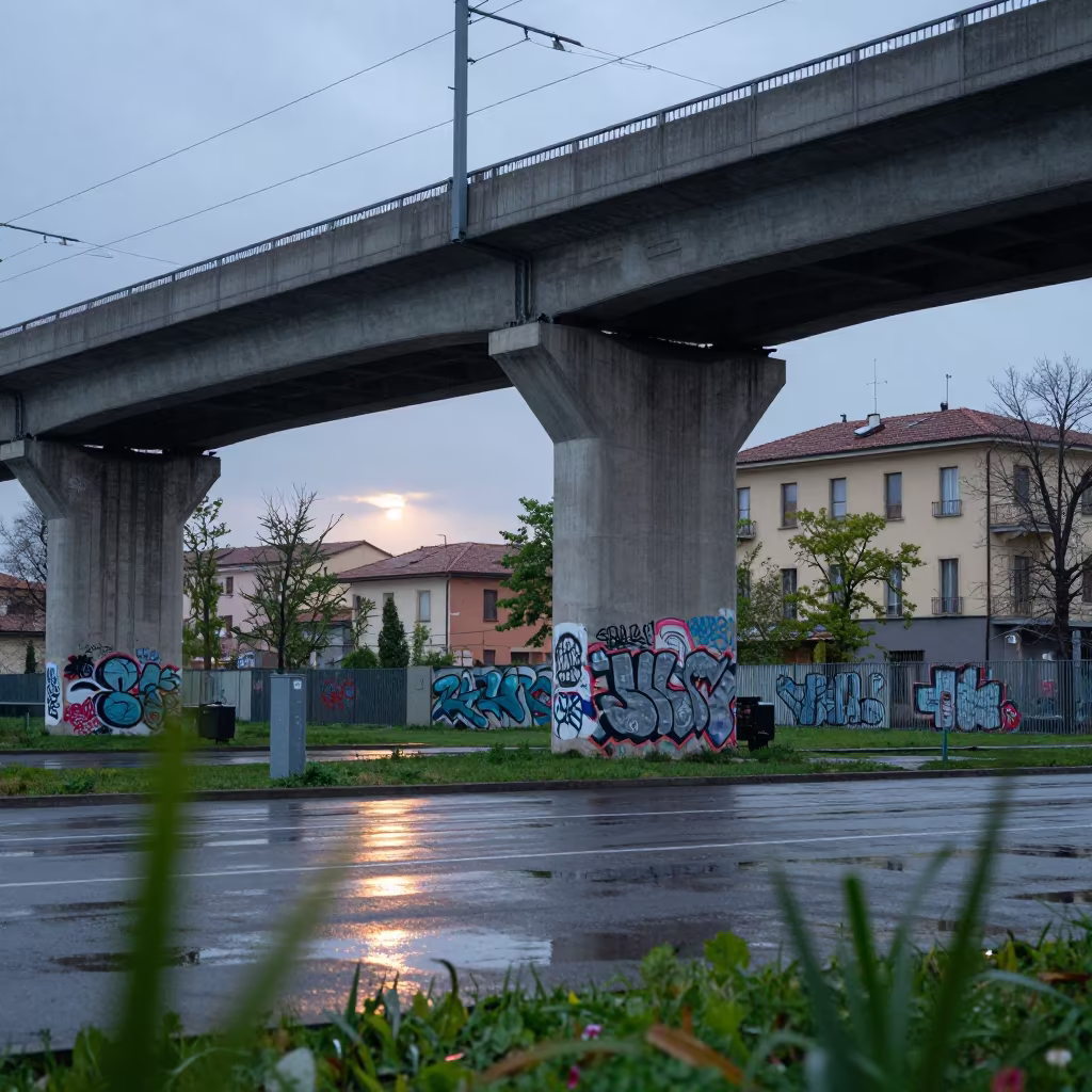 Graffiti on Overpass Column Under Rainy Parma Sky in under an elevated train line in Parma