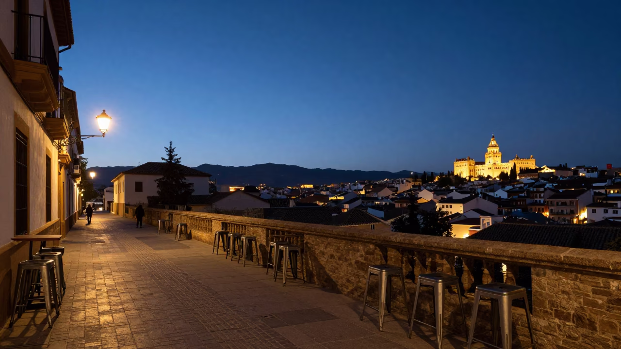 Granada Spain predawn street scene with metal stools and quiet urban architecture in in Granada, Spain