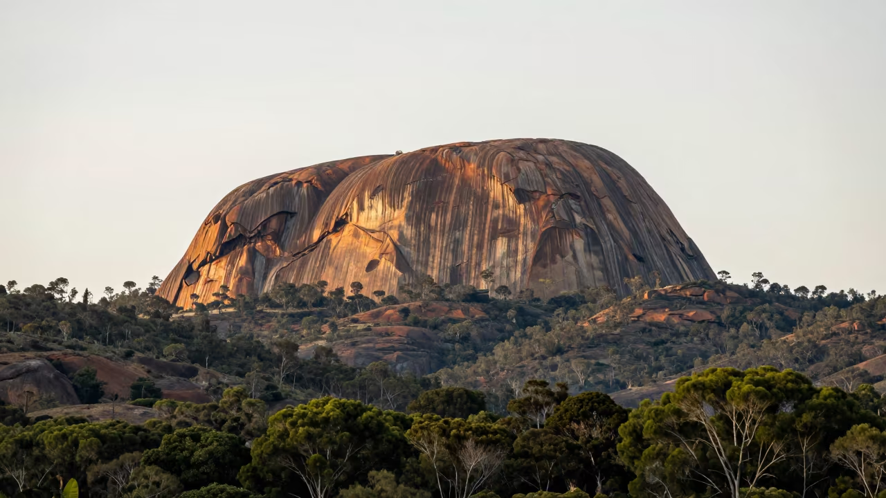 Golden Granite Dome Above South Australian Forest in from a ridge above layered foothills in South Australia