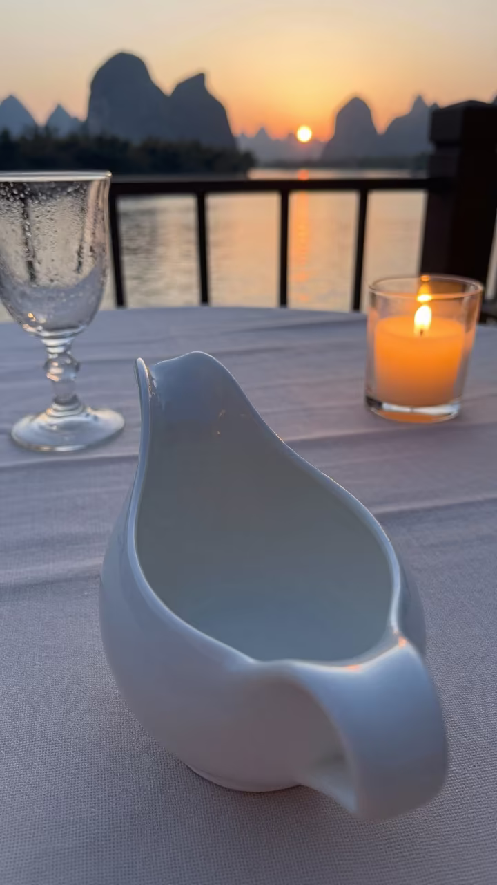 Gravy Boat on Linen Table at Sunset in on a pier railing near Guilin