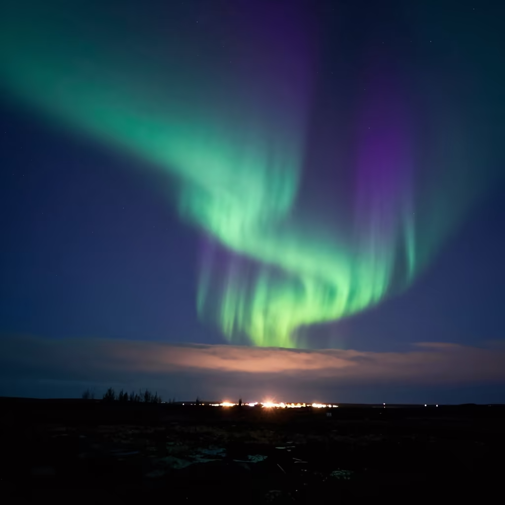 Green Aurora Borealis Over Iceland Night Sky in beneath thin cloud gaps and stars in Iceland