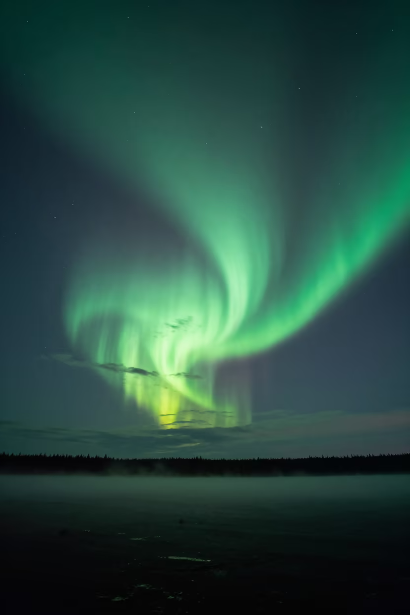 Green Aurora Corona Overhead in Canadian Night in beneath thin cloud gaps and stars in Canada