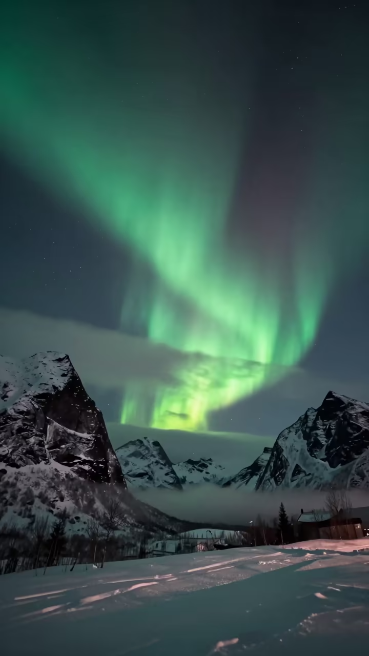 Green Aurora Ribbon Over Finnish Mountain Peaks in under the clearest stretch of sky in Finland