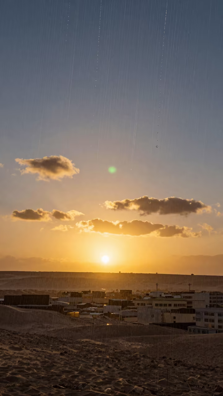 Green Flash Sunset Over Aswan With Upward Rain in beneath fast-moving cloud bands near Aswan