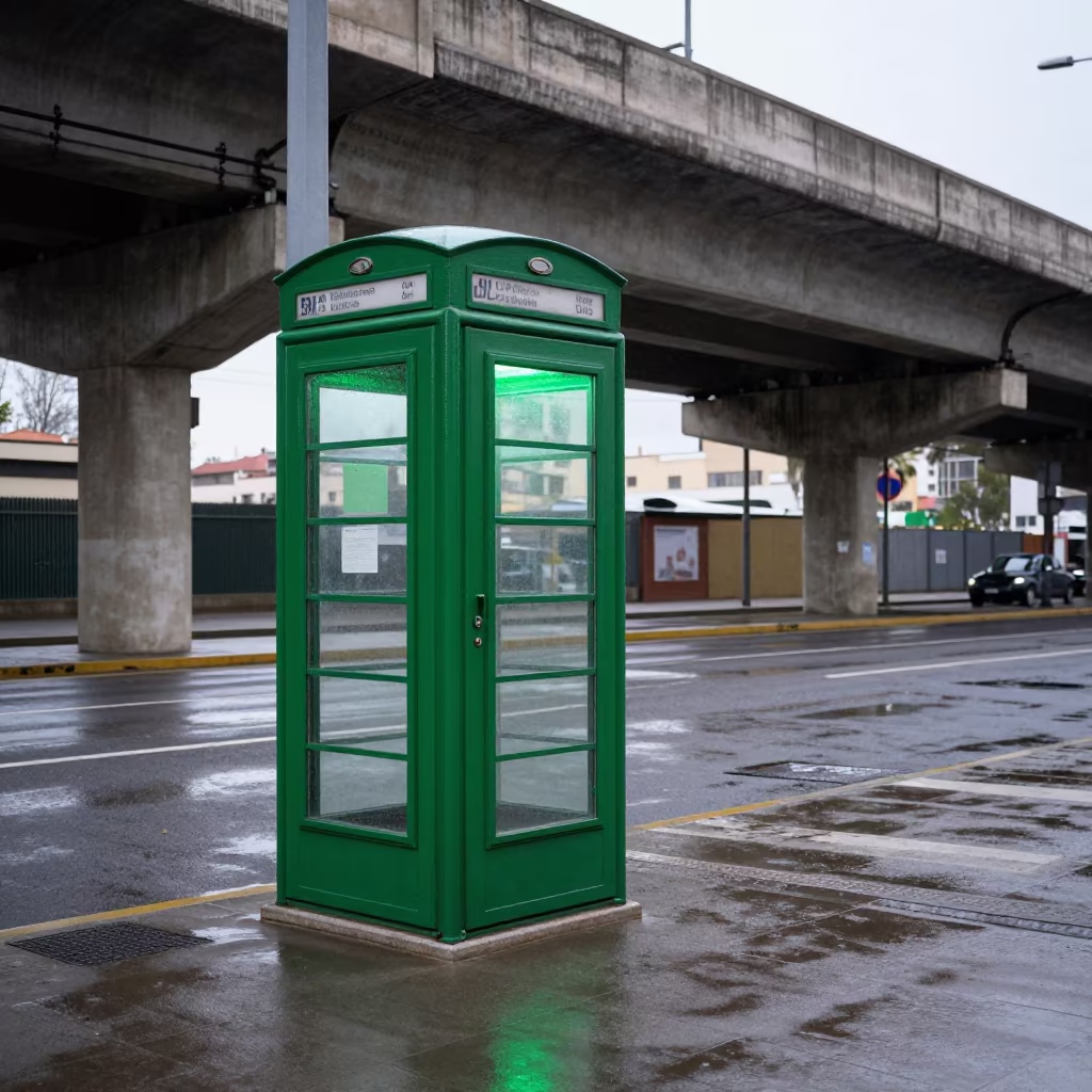 Green Phone Booth Under Valencia Train Tracks in under an elevated train line in Valencia
