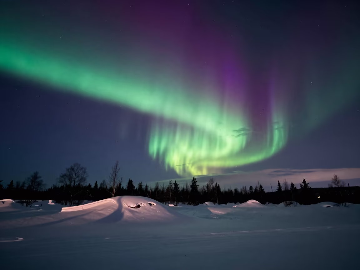 Green and Purple Aurora Over Rovaniemi in beneath thin cloud gaps and stars near Rovaniemi
