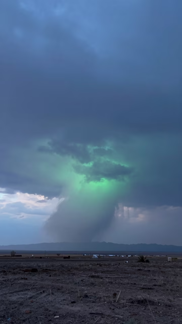 Green Tinted Wall Cloud Over Turkmenistan Thunderheads in over a horizon of stacked thunderheads in Turkmenistan
